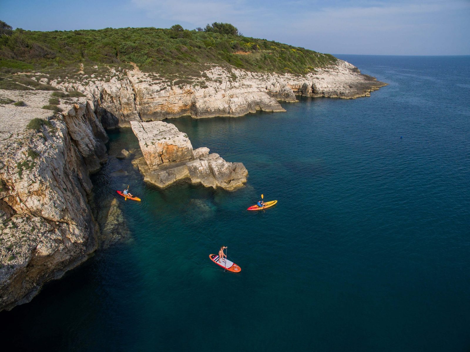 Kayaking between coves at Kamenjak
